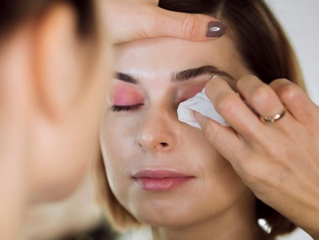 woman-having-makeup-removed-with-cotton-pad