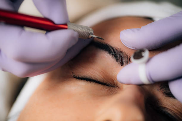 Microblading procedure on eyebrows done by a professional in a clinic-setting.