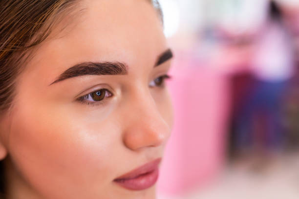 Close-up portrait of a young woman with well-groomed eyebrows cosmetic eyebrow tattoo Melbourne